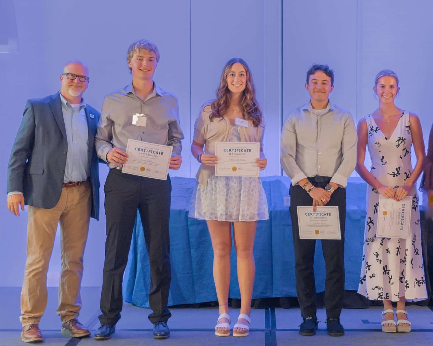 Pipefitters-Industry-Fund-scholarship-recipients-receiving-awards-on-stage-at-an-MCAKC-event